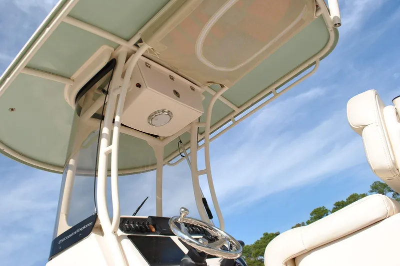 Slide: The Image of 2021 Grady-White 251 Coastal Explorer boat docked in a marina, surrounded by other vessels. - 51