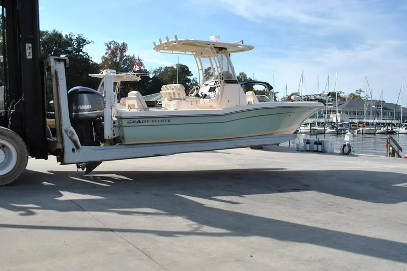 Slide: The Image of 2021 Grady-White 251 Coastal Explorer boat navigating marina waters. - 53