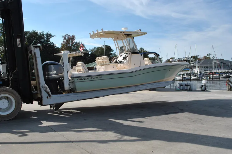 Slide: The Image of 2021 Grady-White 251 Coastal Explorer boat navigating marina waters. - 54