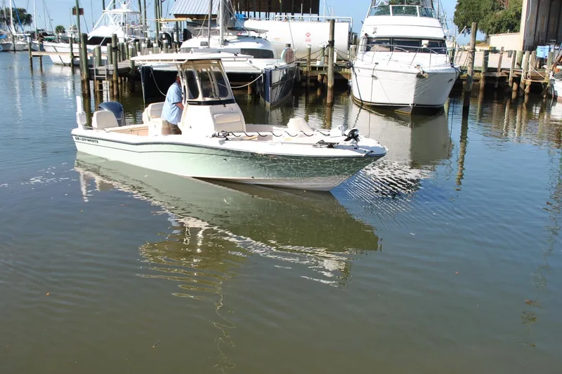 Slide: The Image of 2021 Grady-White 251 Coastal Explorer boat docked in a marina. - 55