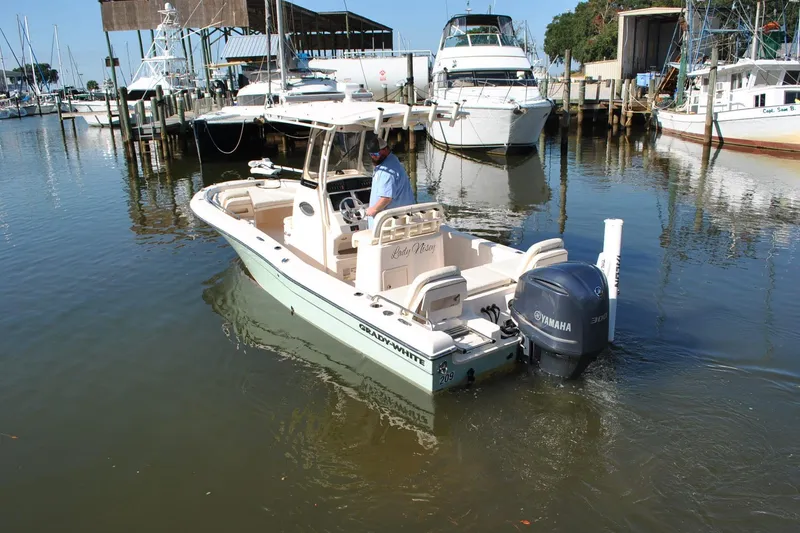 Slide: The Image of 2021 Grady-White 251 Coastal Explorer boat in marina, featuring Yamaha engine. - 63