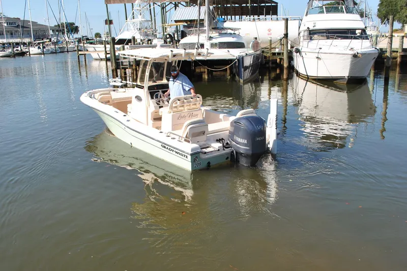 Slide: The Image of 2021 Grady-White 251 Coastal Explorer boat docked in marina with Yamaha engine. - 64