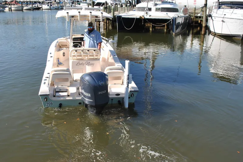 Slide: The Image of 2021 Grady-White 251 Coastal Explorer boat docked in marina, rear view. - 67