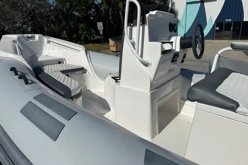 Slide: The Image of 2024 Caribe DL-20S boat interior with modern seating and steering console. - 10