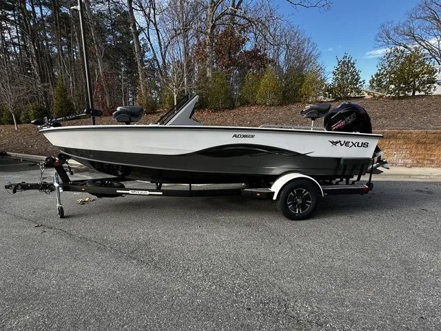 The Image of 2024 Vexus ADX190 boat on trailer, parked outdoors, showcasing sleek design and modern features. - 1