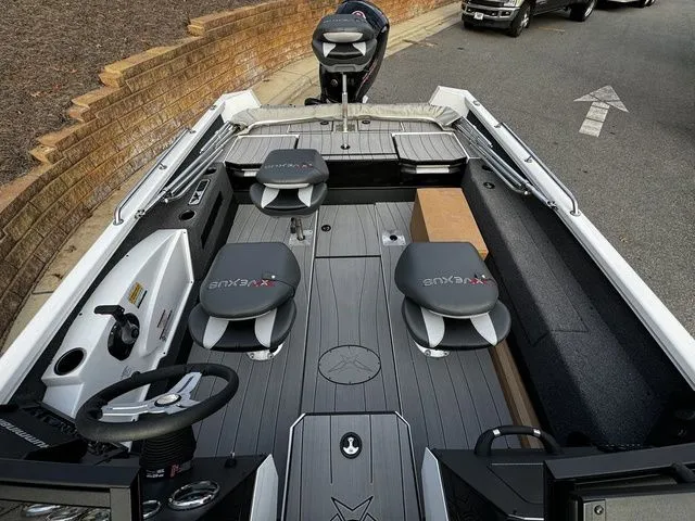 Slide: The Image of 2024 Vexus ADX190 boat interior with seating and steering wheel, parked on a road. - 13