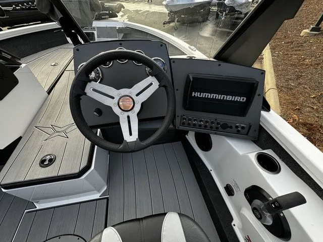 Slide: The Image of 2024 Vexus ADX190 boat cockpit with steering wheel and Humminbird navigation system. - 7