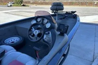 Slide: The Image of 2014 Tracker Pro Team 190 TX boat interior with steering wheel and dashboard gauges. - 2