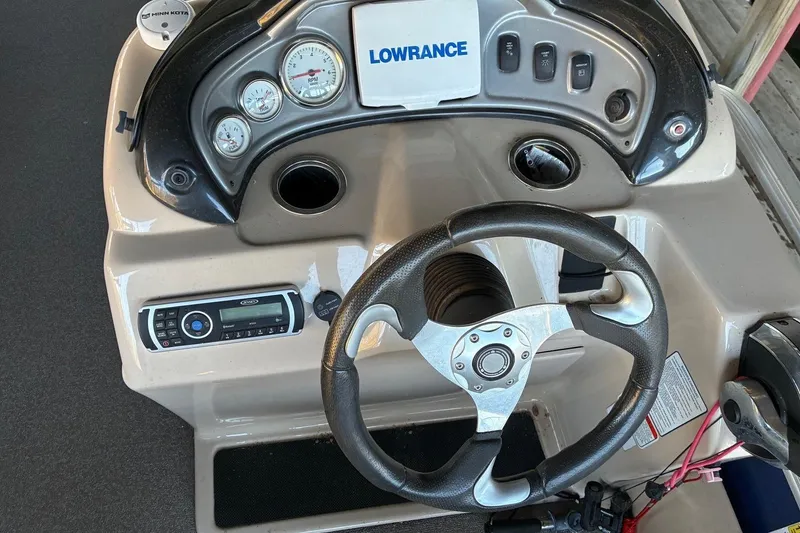 Slide: The Image of 2017 Sun Tracker Fishin' Barge 22 DLX dashboard with steering wheel and controls. - 11