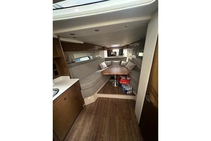 Slide: The Image of 2016 Cruisers 390 Express interior with cozy seating and wooden flooring. - 4