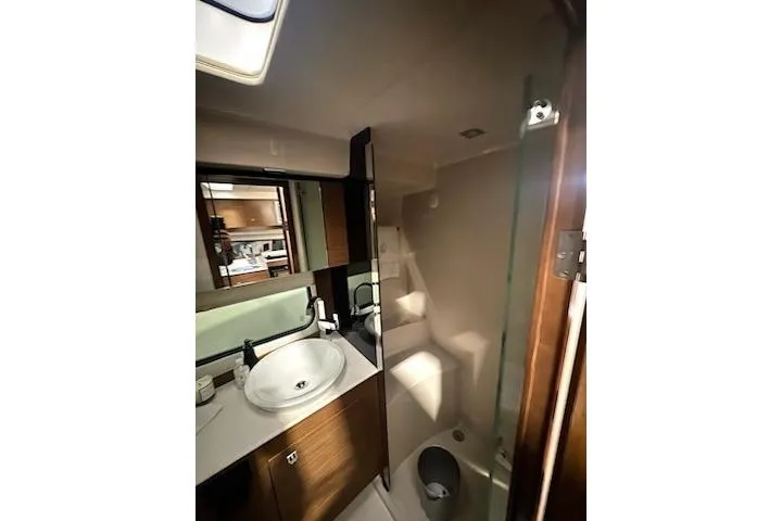 Slide: The Image of 2016 Cruisers 390 Express yacht bathroom with modern sink and shower. - 6