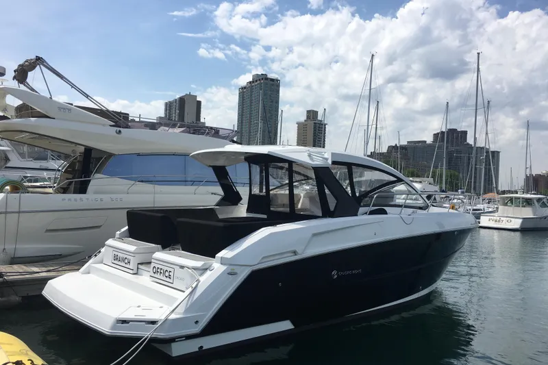 The Image of 2016 Cruisers 390 Express yacht docked in a marina with city skyline. - 0