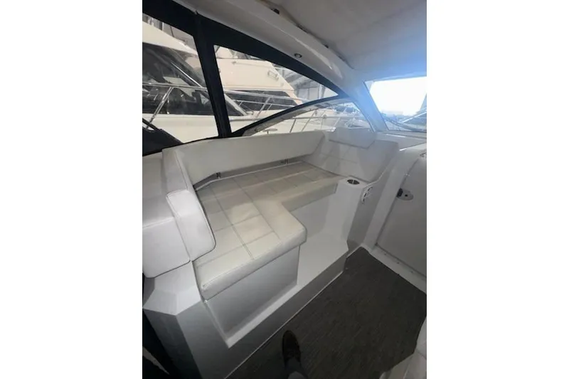 Slide: The Image of 2016 Cruisers 390 Express interior with white seating and modern design. - 2