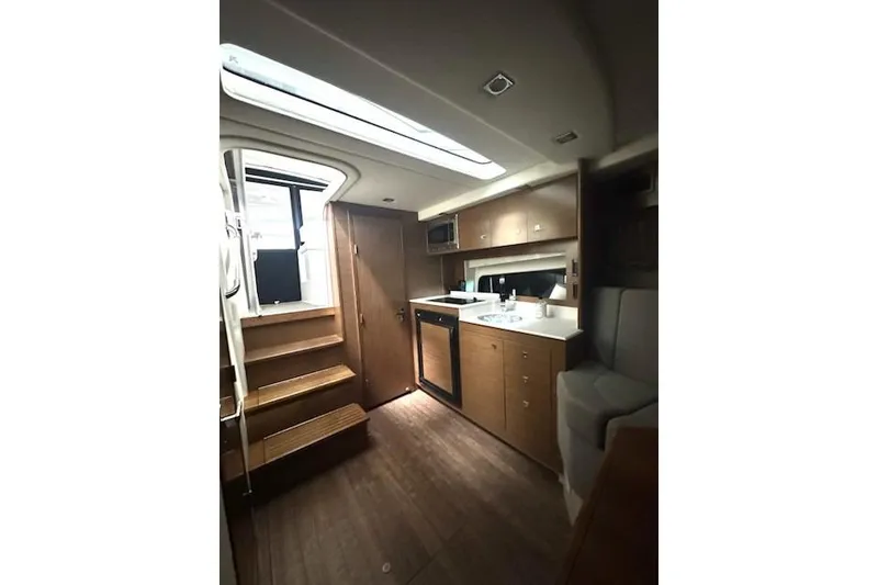 Slide: The Image of 2016 Cruisers 390 Express yacht interior with wooden cabinetry and modern kitchen amenities. - 3