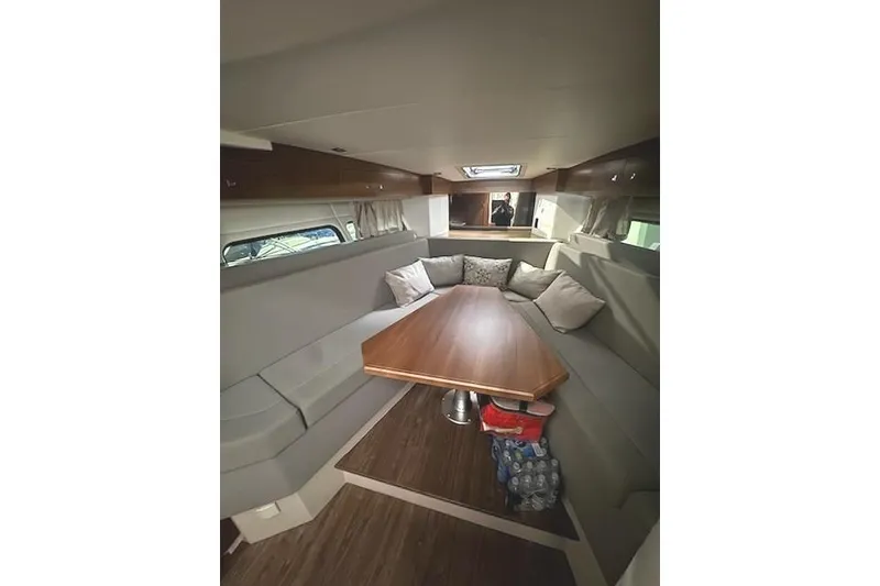 Slide: The Image of 2016 Cruisers 390 Express interior with cozy seating and wooden table. - 5