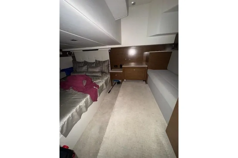 Slide: The Image of 2016 Cruisers 390 Express cabin interior with bed and seating area. - 7