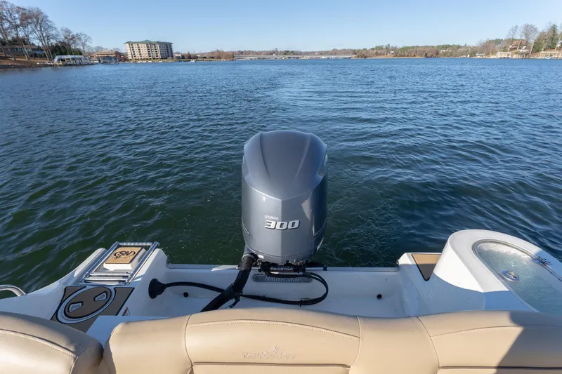 Slide: The Image of 2020 NauticStar 2602 Legacy boat with Yamaha 300 engine on a calm lake. - 12