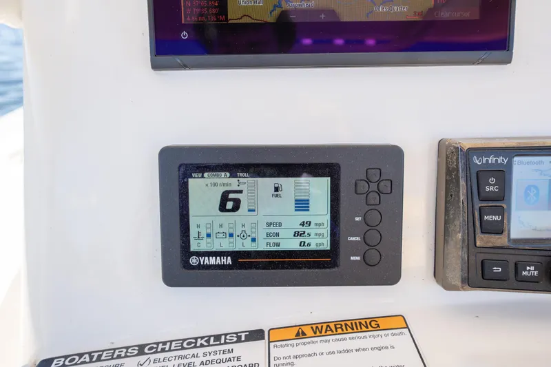 Slide: The Image of Yamaha display on 2020 NauticStar 2602 Legacy boat dashboard, showing speed and fuel data. - 14