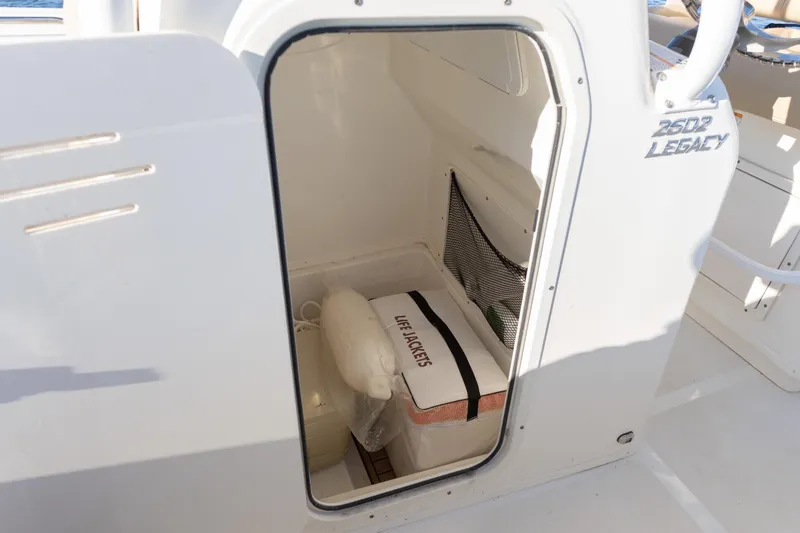 Slide: The Image of 2020 NauticStar 2602 Legacy boat storage with life jackets inside. - 17