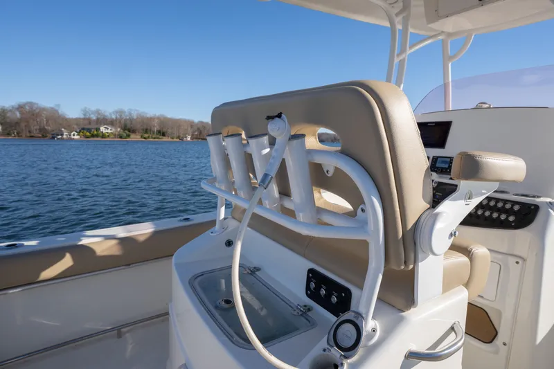 Slide: The Image of 2020 NauticStar 2602 Legacy boat interior with helm seat and water view. - 9