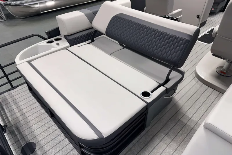 Slide: The Image of 2026 Sylvan L3 CLZ DH Platinum boat interior with gray seating and cup holders. - 18
