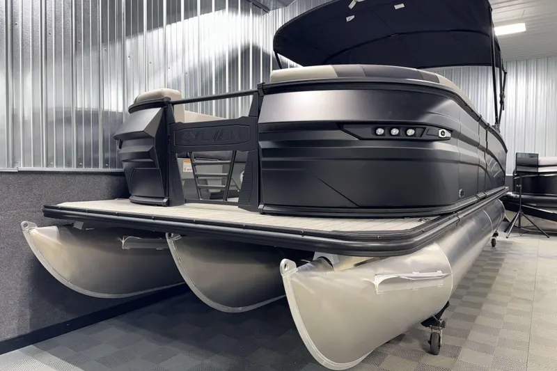Slide: The Image of 2026 Sylvan L3 CLZ DH Platinum pontoon boat in showroom, featuring sleek design and modern amenities. - 22