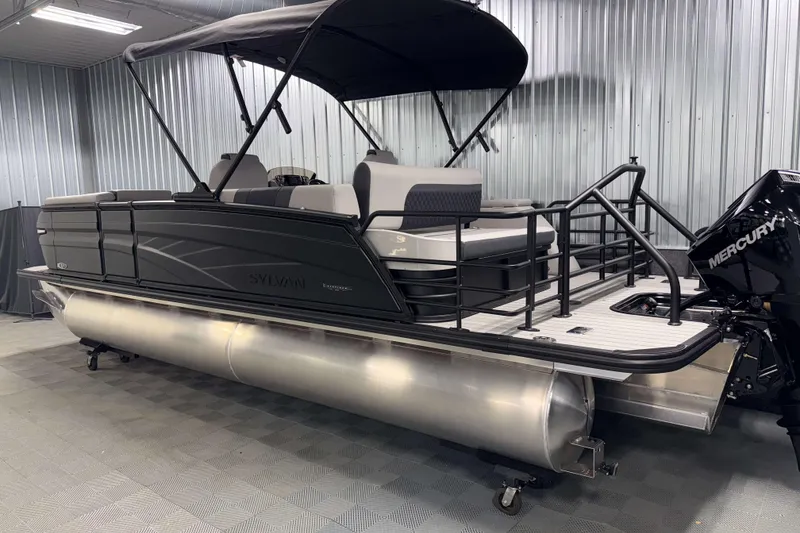 Slide: The Image of 2026 Sylvan L3 CLZ DH Platinum pontoon boat with Mercury engine in a showroom. - 26