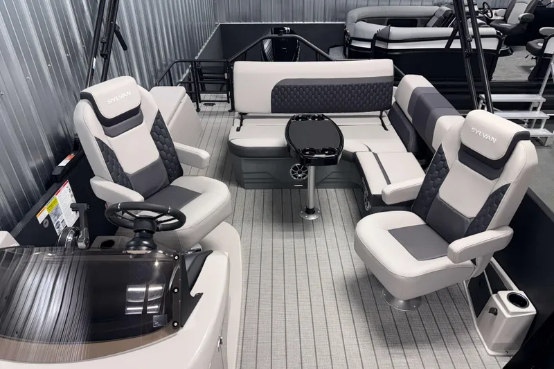 Slide: The Image of 2026 Sylvan L3 CLZ DH Platinum pontoon boat interior with luxurious seating and modern design. - 8