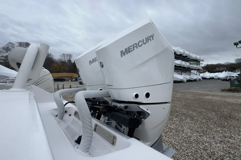 Slide: The Image of 2024 Jupiter 32 FS boat with Mercury outboard engines in a marina setting. - 10