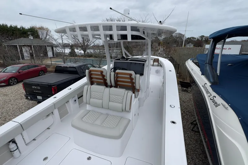 Slide: The Image of 2024 Jupiter 32 FS boat with sleek design and spacious seating in a marina setting. - 11