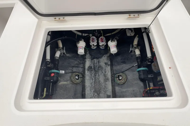 Slide: The Image of 2024 Jupiter 32 FS boat compartment with visible plumbing and mechanical components. - 16