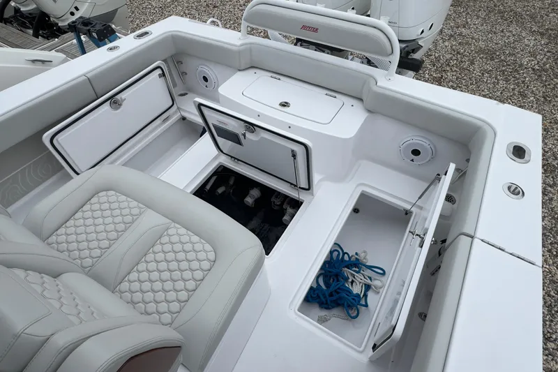 Slide: The Image of 2024 Jupiter 32 FS boat interior with storage compartments and seating. - 17