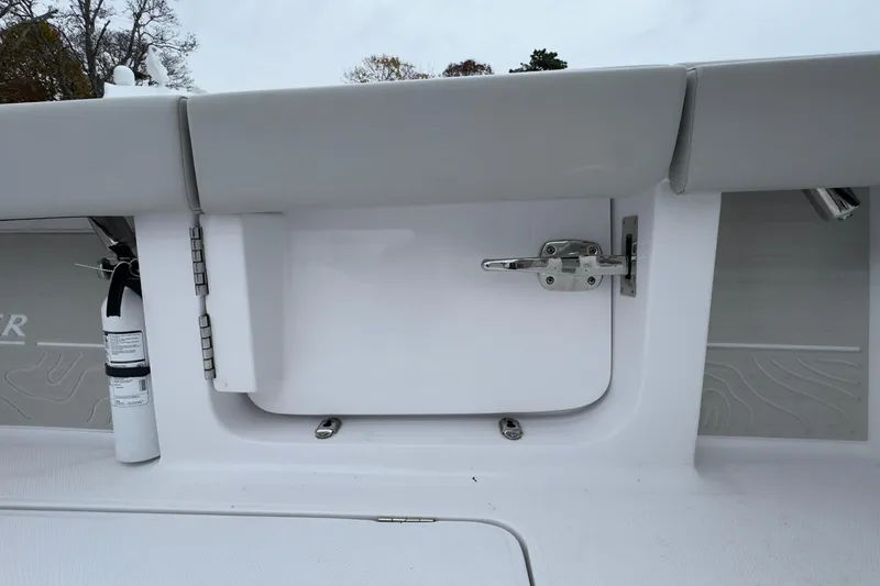 Slide: The Image of 2024 Jupiter 32 FS boat interior with safety equipment and storage compartment. - 21