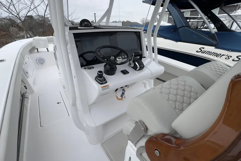 Slide: The Image of 2024 Jupiter 32 FS boat cockpit with modern steering and controls. - 26