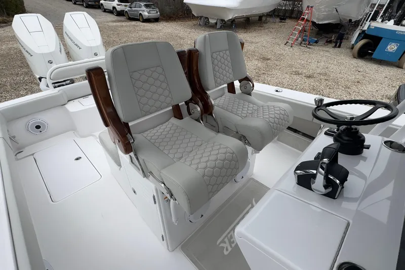 Slide: The Image of 2024 Jupiter 32 FS boat interior with dual seats and steering console. - 27