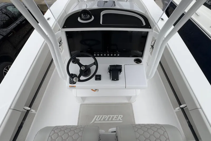 Slide: The Image of 2024 Jupiter 32 FS boat helm with steering wheel and control panel. - 28