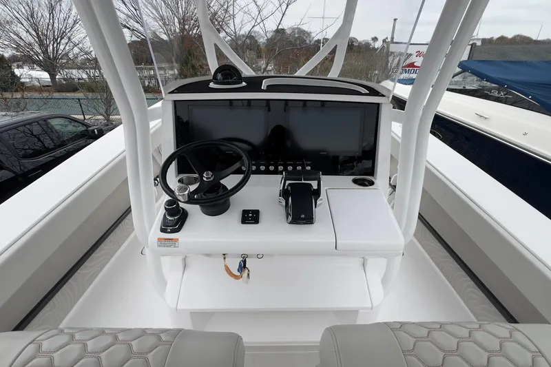 Slide: The Image of 2024 Jupiter 32 FS boat console with steering wheel and navigation display. - 29