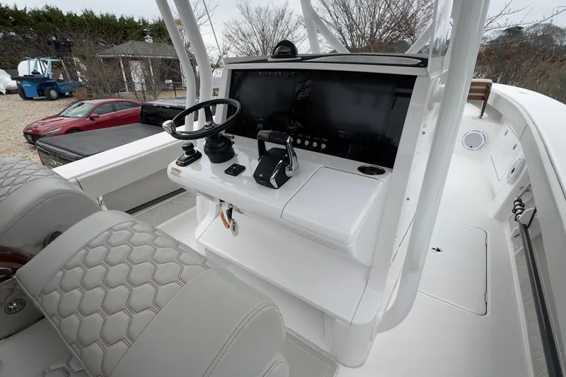 Slide: The Image of 2024 Jupiter 32 FS boat cockpit with steering wheel and control panel. - 32