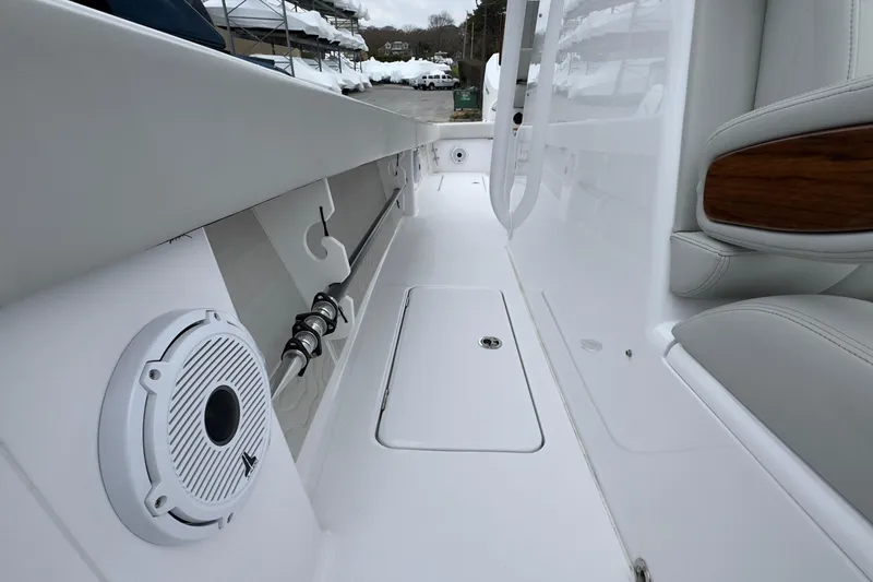 Slide: The Image of 2024 Jupiter 32 FS boat interior with speaker and storage compartment. - 36