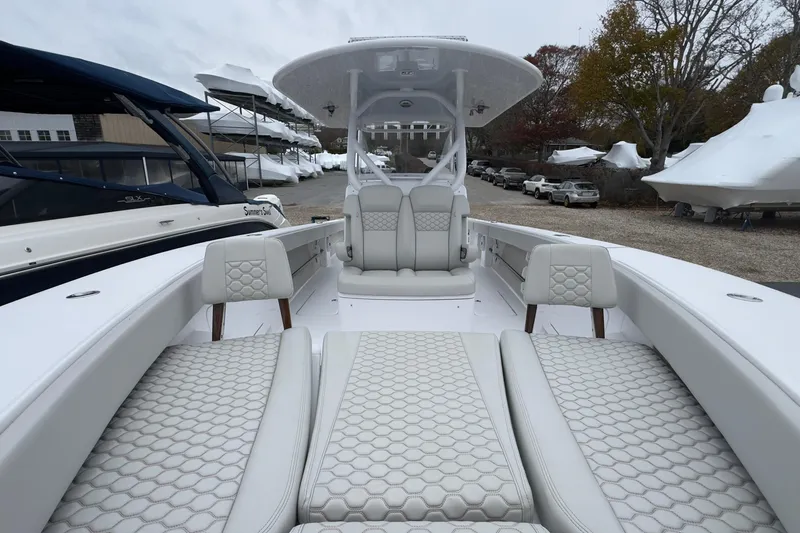 Slide: The Image of 2024 Jupiter 32 FS boat with luxurious seating and modern design in a marina setting. - 41