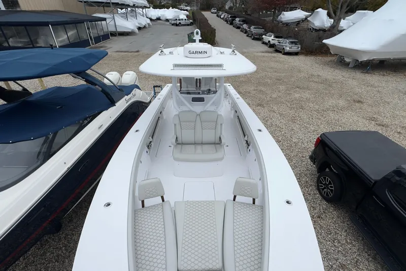 Slide: The Image of 2024 Jupiter 32 FS boat with Garmin equipment, parked in a marina lot. - 45