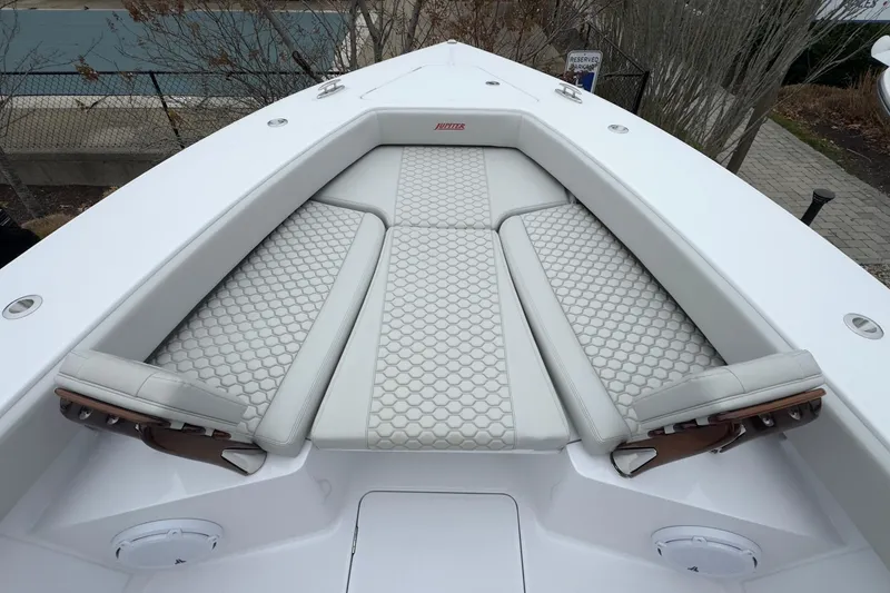 Slide: The Image of 2024 Jupiter 32 FS boat with luxurious white seating and hexagonal pattern design. - 48