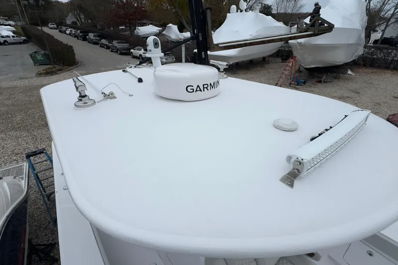 Slide: The Image of 2024 Jupiter 32 FS boat with Garmin equipment on deck, parked in a marina. - 50