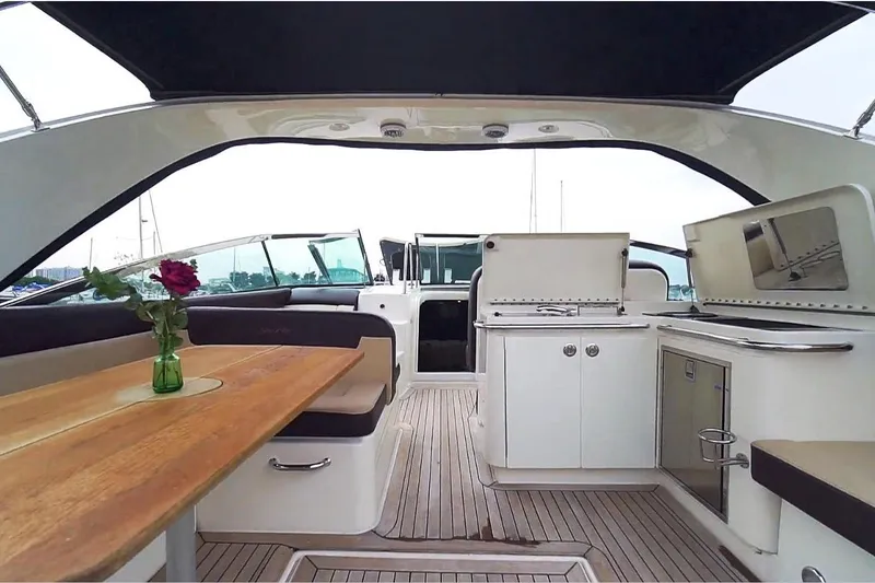 Slide: The Image of 2015 Sea Ray 370 Venture yacht interior with dining area and kitchenette. - 12
