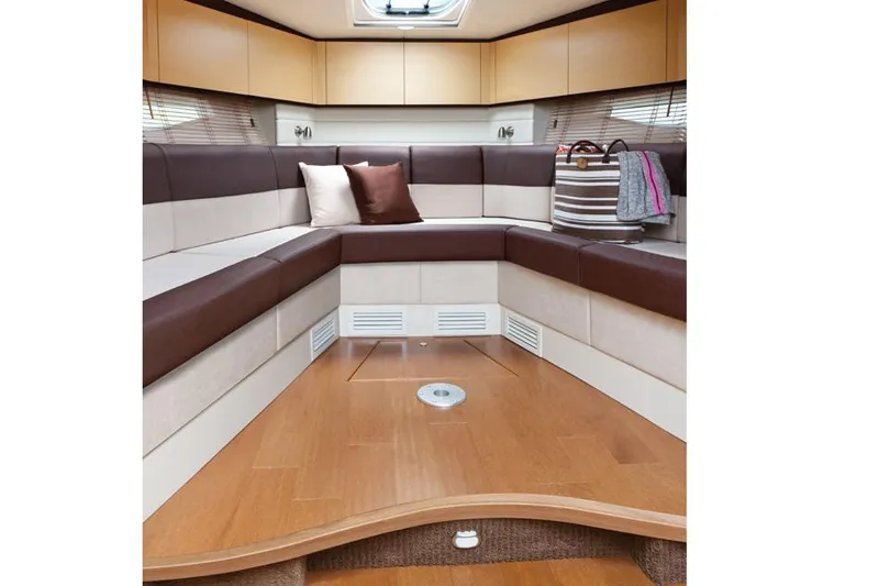 Slide: The Image of Manufacturer Provided Image: 2015 Sea Ray 370 Venture interior cabin with U-shaped seating and wooden flooring. - 8