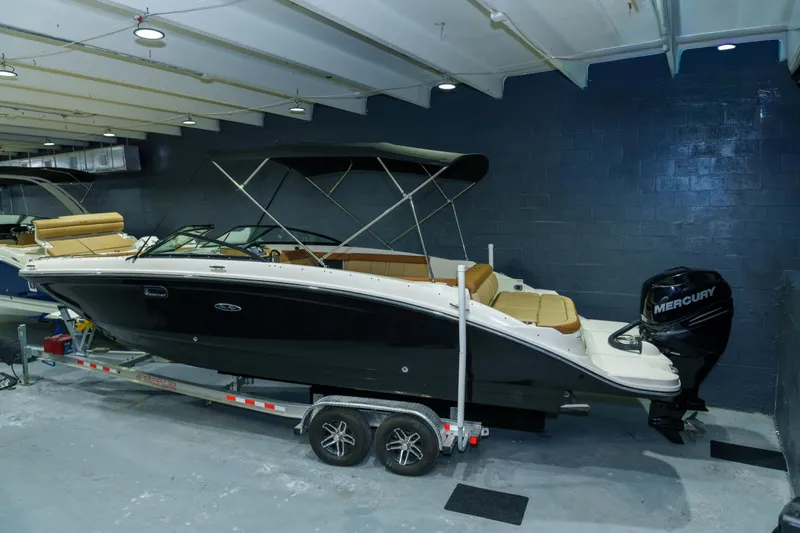 The Image of 2015 Sea Ray 270 Sundeck boat with Mercury engine on trailer in showroom. - 0