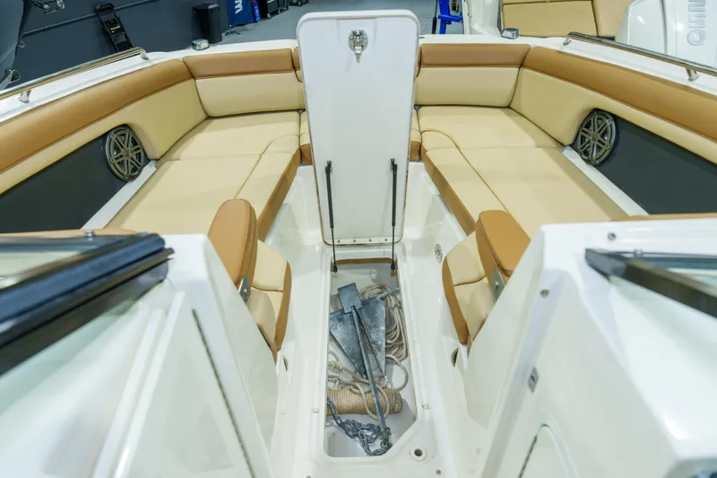 Slide: The Image of 2015 Sea Ray 270 Sundeck interior with beige seating and anchor storage. - 10