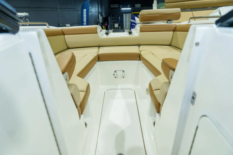 Slide: The Image of 2015 Sea Ray 270 Sundeck interior with tan seating and spacious layout. - 11