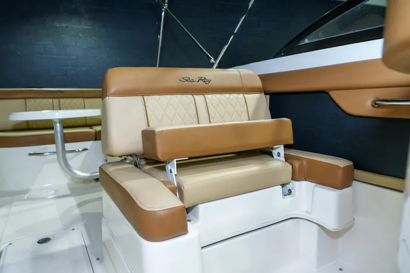 Slide: The Image of 2015 Sea Ray 270 Sundeck interior with tan leather seating and table. - 18