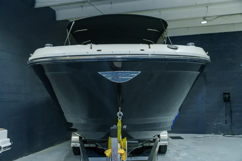 Slide: The Image of 2015 Sea Ray 270 Sundeck boat in indoor storage, front view. - 2